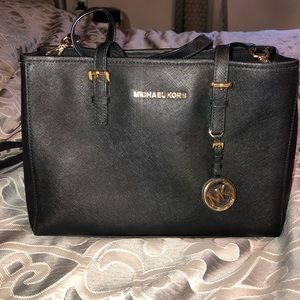 Micheal Kors black and gold purse